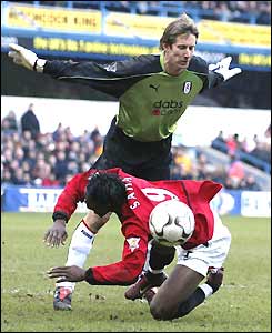 Louis Saha goes down under a challenge from Edwin van der Sar