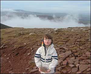 Philip Coleman's four-year-old daughter Emily collecting rocks at the top of Pen-y-fan