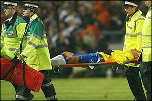 Gilberto Silva is carried off with a leg injury in the first half