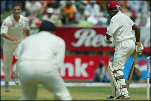 Simon Jones watches in delight as Andrew Flintoff holds an edge from Brian Lara