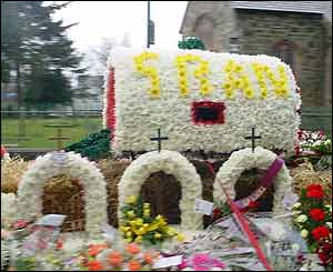 A truck adorned with flowers was part of the funeral procession