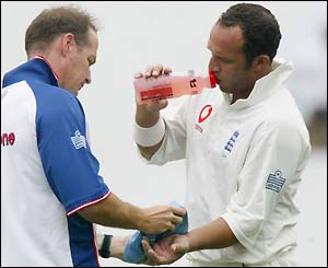 Mark Butcher gets treatment on a hand injury