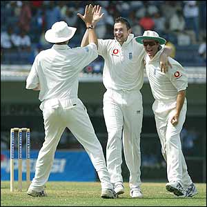 Andrew Flintoff, Steve Harmison and Michael Vaughan celebrate the wicket of 