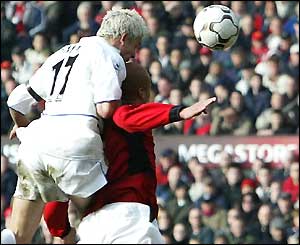 Leeds' Alan Smith beats Wes Brown to the ball to score the equaliser