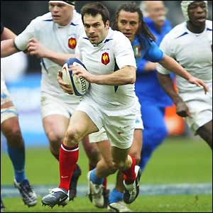 Wing Christophe Dominici sprints clear of the Italian defence