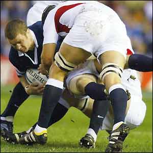 Scotland's Gordon Bulloch is tackled by England's Ben Kay