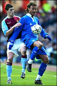 Birmingham's Christophe Dugarry tries to hold off Gareth Barry