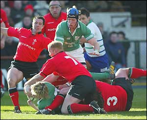 Captain Brian O'Driscoll powers through the Welsh tacklers to score Ireland's second try