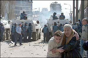 Injured people are led away as UN peacekeepers step in to separate the two sides in the northern town of Mitrovica