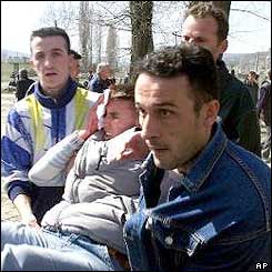 Ethnic Albanians carry away wounded man