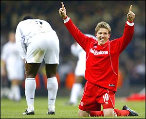 Juninho celebrates at the final whistle as Bruno N'Gotty is disappointed