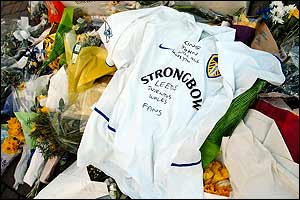 Flowers and a Leeds shirt are left by the statue of Billy Bremner
