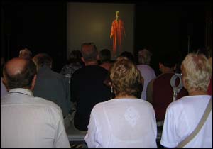 Some of the many people who attended the event watching films on Saudi heritage in a Bedouin tent