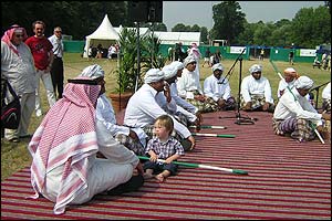 A young boy sitting with the Saudi dance troop who gave a performance to much applause