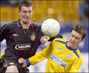 Celtic's Chris Sutton battles for the ball with Michal Dolezal