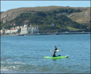 Canoes in Llandudno bay making the most of the sun, from Greg Robbins