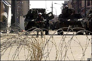 French Nato peacekeepers guard bridge over the River Ibar in Mitrovica behind razor wire