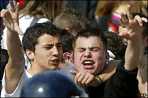 Two young Serbs flash a three fingered victory salute during 