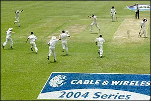 England's fielders celebrate Lara's dismissal 