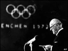 IOC PResident Avery Brundage with Olympic logo in background