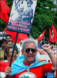 Brazil anti-war protester holds placard depicting Bush and Hitler at rally in Rio