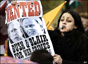 Woman holds banner and blows whistle at protest in Glasgow, Scotland