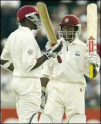 Dwayne Bravo and Shivnarine Chanderpaul salute the crowd at Old Trafford