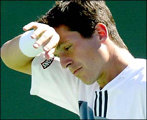 Tim Henman wipes his brow with a sweatband