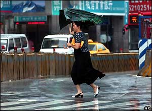 Woman walks in the rain in Taipei