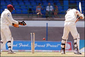 Simon Jones is bowled by Chris Gayle for one 