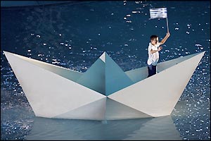 The focus of the crowd falls onto a small Greek boy