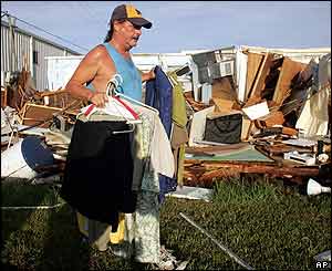 Dan Strong removes clothing from his mobile home in Punta Gorda a day after Charley struck