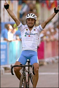 Italy's Paolo Bettini celebrates winning the men's cycling road race