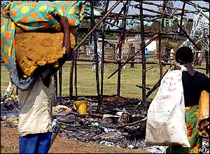 Man taking valuables from the remains of a house.