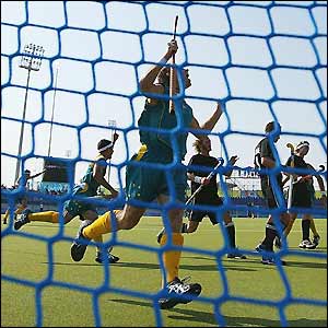 The Australian hockey team celebrate a goal against New Zealand 