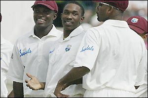 Fidel Edwards and Dwayne Bravo smile as they claim seven of England's wickets between them