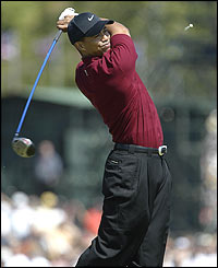 Tiger Woods tees off on the first