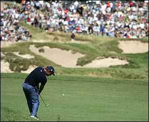 McGinley takes his second shot on the eighth hole at Whistling Straits