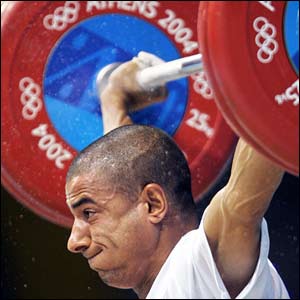 Iraqi Ali Mohammed competes during the men's 56 kg, Group B, weightlifting competition of the Olympic Games at Nikaia Olympic Weightlifting Hall in Athens