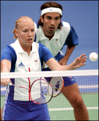 Emms and Robertson eye the shuttlecock while in action