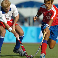 Graham Moodie and Seo Jong-Ho jostle for the ball