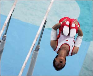 Takehiro Kashima of Japan dismounts the parallel bars