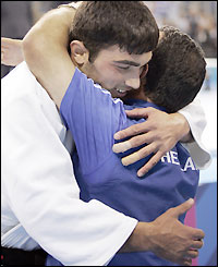 Ilias Iliadis hugs Roman Gontyuk