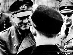 In his last official photo, Adolf Hitler leaves the safety of his bunker to award decorations to members of Hitler Youth