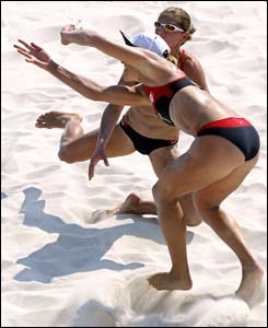 Canadian players Guylaine Dumont and Annie Martin loose the ball during their third round beach volleyball victory over Norway