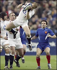 England scrum-half Matt Dawson claims the ball as Christophe Dominici of France looks on