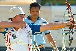 Galiazzo (front) aims his arrow while his opponent waits for his turn