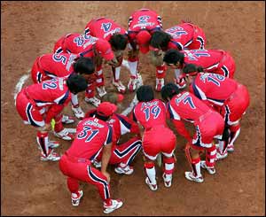 The Japan softball team discuss tactics