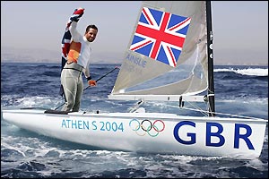 Ben Ainslie punches the air in delight after securing gold in the Finn class