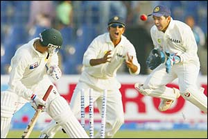 Sachin Tendulkar takes the wicket of Moin Khan for 17 with the last ball of the day